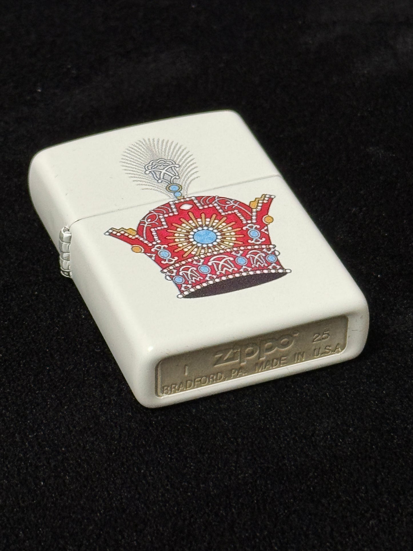White lighter with red jeweled Pahlavi Crown design on black 