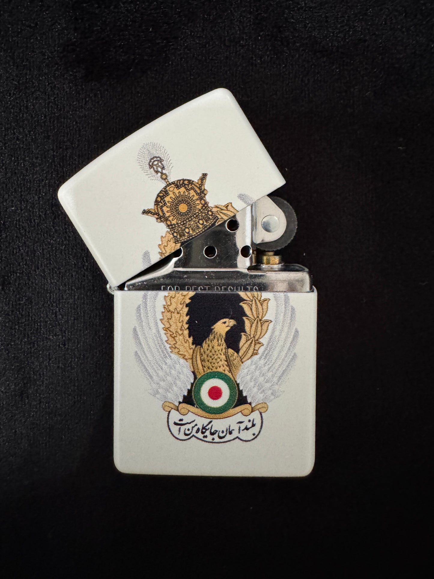 White lighter with Imperial Iranian Air Force emblem, golden eagle, silver wings, royal crown, and “The High Sky Is My Place” motto